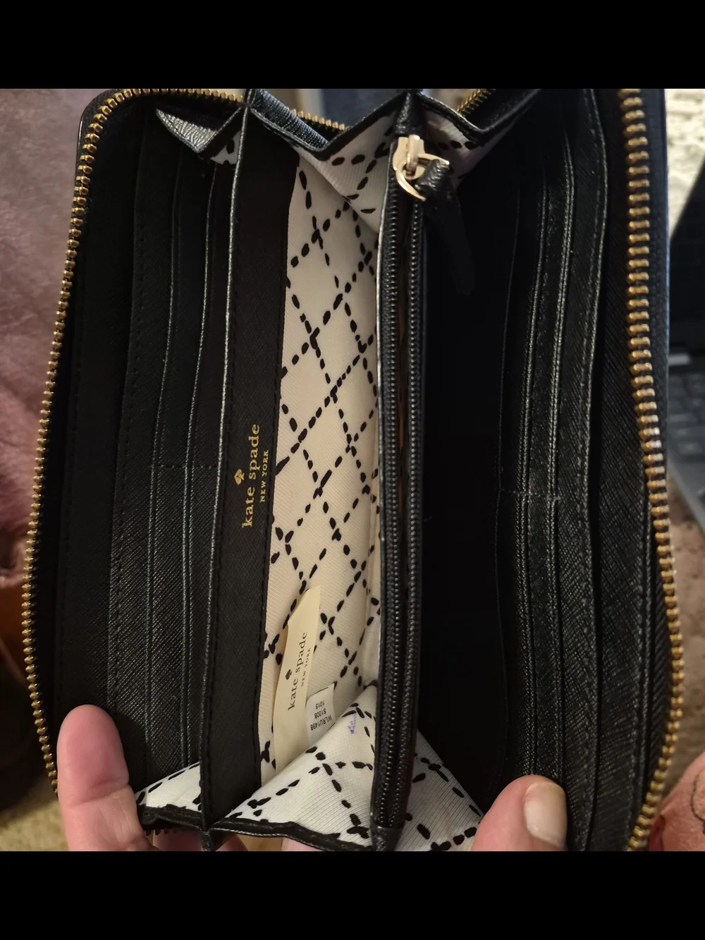 kate spade Newbury Lane Zip around black wallet with gold logo plaque